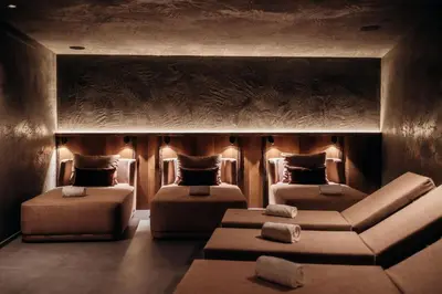 a living room with two beds and a couch at Hotel Else in Selva di Val Gardena