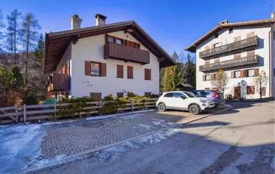 a white car parked in front of a building at Lovely Apartment In San Vito Di Cadore in San Vito di Cadore