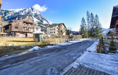 an empty road in a village with a mountain at Lovely Apartment In San Vito Di Cadore in San Vito di Cadore