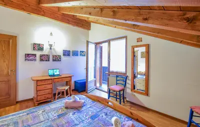 a bedroom with a desk and a table and chairs at Lovely Apartment In San Vito Di Cadore in San Vito di Cadore