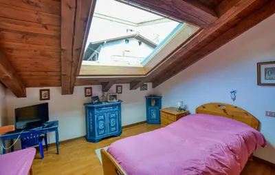 a bedroom with a bed and a window at Lovely Apartment In San Vito Di Cadore in San Vito di Cadore