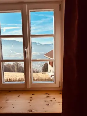 a window with a view of a field at Oberraut in Brunico