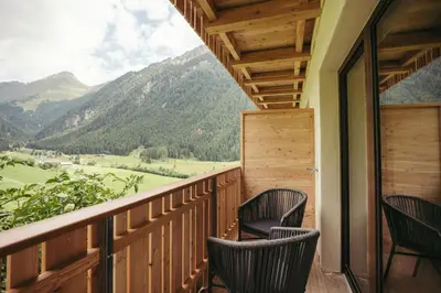 a balcony with chairs and a view of mountains at HoferVals in Valles