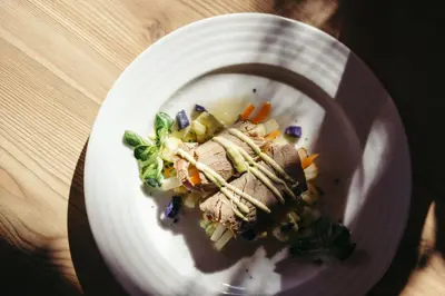 a plate of food with meat and vegetables on a table at HoferVals in Valles