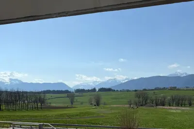 a view of a field with mountains in the background at AlpinVista- Le Maddalene in Cavareno