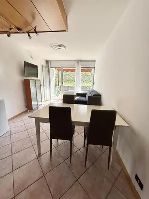 a dining room with a table and chairs at AlpinVista- Le Maddalene in Cavareno
