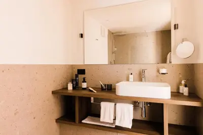 a bathroom with a sink and a mirror at Hotel Paradies in Tirolo