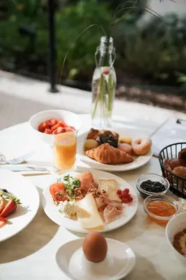 a table topped with plates of food and eggs at Hotel Paradies in Tirolo