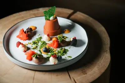 a plate with a dessert on a wooden plate at Hotel Paradies in Tirolo
