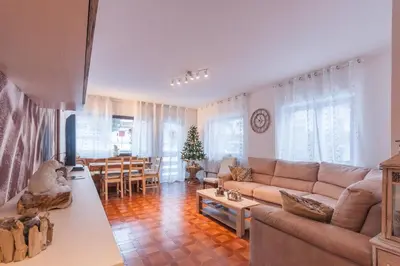 a living room with a couch and a table at Condominio Val Biois in Falcade