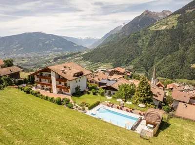 an estate in the mountains with a swimming pool at Hotel Garni Alpes in Schenna