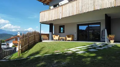 a house with a yard with a table and chairs at Villa Lara Laerche in Castelrotto