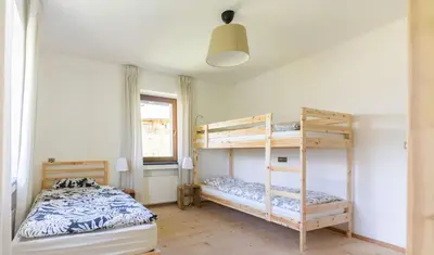 a bedroom with two bunk beds and a window at Large apartment with panoramic view in Meluno