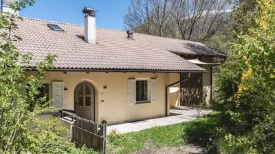 a small house with a brown roof at Large apartment with panoramic view in Meluno
