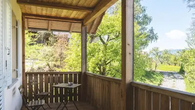 a screened in porch with a table and chairs on it at Large apartment with panoramic view in Meluno