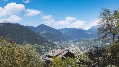a view of a valley with mountains in the background at Large apartment with panoramic view in Meluno