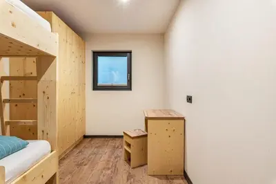 a room with two bunk beds and a window at Villa Lara Fichte in Castelrotto