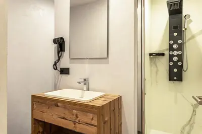 a bathroom with a sink and a mirror on the wall at Villa Lara Fichte in Castelrotto