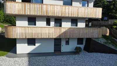 a building with a wooden deck on top of it at Villa Lara Fichte in Castelrotto