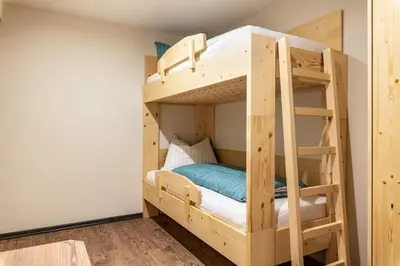a bunk bed in a small room with a bunk bed in a bedroom at Villa Lara Fichte in Castelrotto