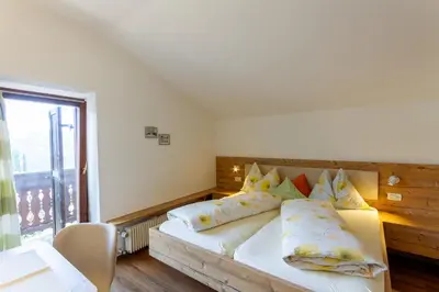 a bedroom with a bed with pillows and a window at Appartments Moarhof in Vols am Schlern