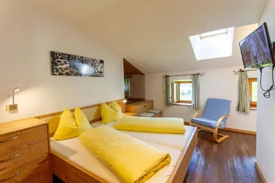 a bedroom with two beds with yellow pillows at Appartments Moarhof in Vols am Schlern