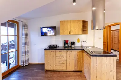a kitchen with wooden cabinets and a sink at Appartments Moarhof in Vols am Schlern