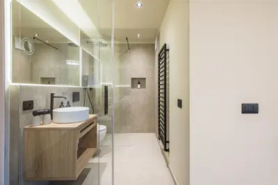 a bathroom with a white sink and a shower at Michael Am Waal in Schenna