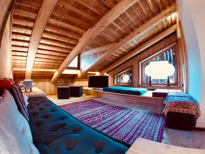 a room with a bed and a large rug on a floor at Stunning Luxury House in Cortina dʼAmpezzo