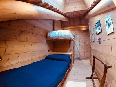 a log cabin bedroom with a bunk bed in it at Stunning Luxury House in Cortina dʼAmpezzo