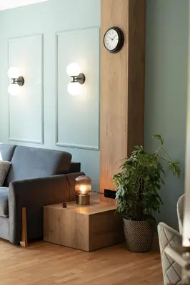 a living room with a couch and a clock on the wall at Apartment Chiusa in Chiusa