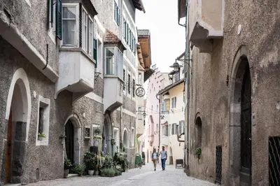 two people walking down an alley between two buildings at Apartment Chiusa in Chiusa