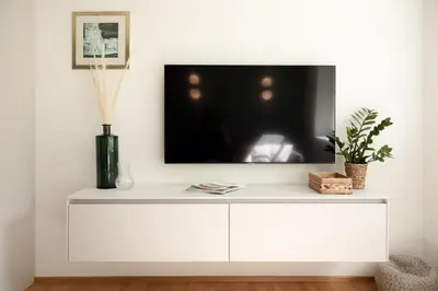 a white entertainment center with a tv on a wall at Apartment Chiusa in Chiusa