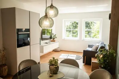 a kitchen and living room with a table and chairs at Apartment Chiusa in Chiusa