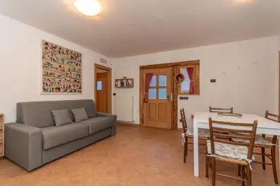 a living room with a couch and a table at Tabia delle Rose in Piaia