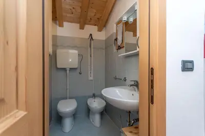 a bathroom with a toilet and a sink at Tabia delle Rose in Piaia