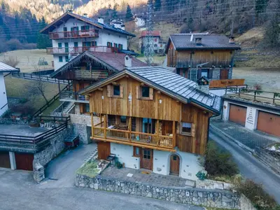 a large wooden house with a balcony in a village at Tabia delle Rose in Piaia