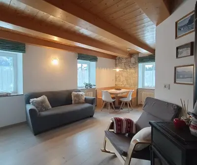 a living room with a couch and a table at Appartamenti Pra Fiorì in Vigo di Fassa