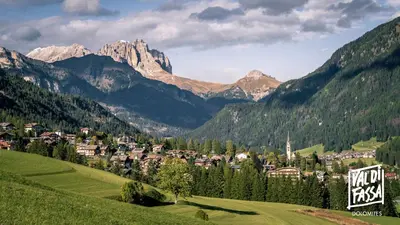 a town in a valley with mountains in the background at Appartamenti Pra Fiorì in Vigo di Fassa