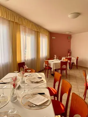 a dining room with white tables and chairs and tablesearcher at Goldenhof in Ora/Auer