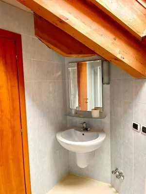 a bathroom with a sink and a mirror at Goldenhof in Ora/Auer