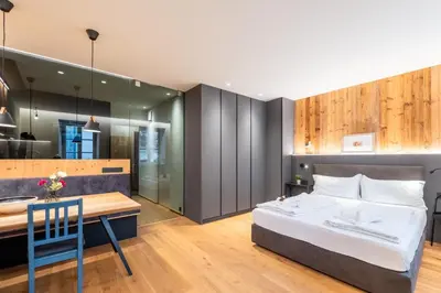 a bedroom with a bed and a dining table at Heart of Bolzano in Bolzano
