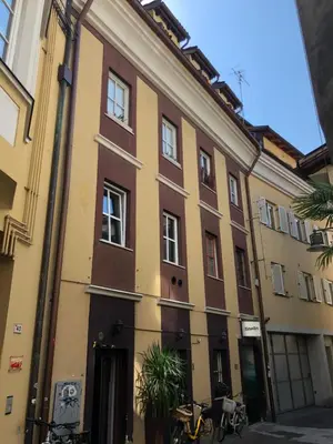 a building on a street with bikes parked outside at Heart of Bolzano in Bolzano