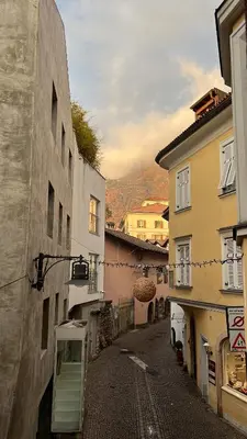 an alley in a town with buildings at Heart of Bolzano in Bolzano