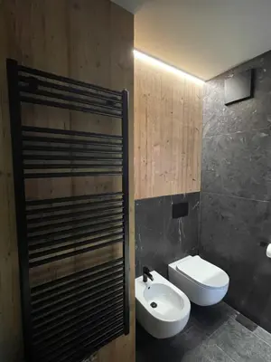 a bathroom with a white toilet and a sink at Heart of Bolzano in Bolzano