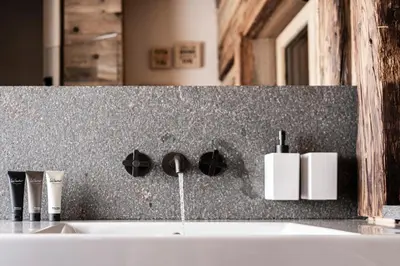 a bathroom with a sink with a faucet at La Mendola Alm-Chalet in Mendola