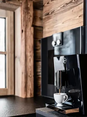 a coffee cup sitting on top of a microwave at La Mendola Alm-Chalet in Mendola