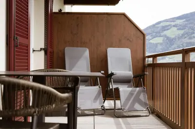 a group of chairs sitting on a balcony at Platterhof in Tirolo