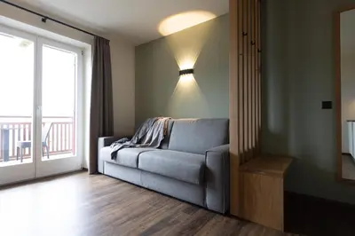 a living room with a couch and a window at Platterhof in Tirolo