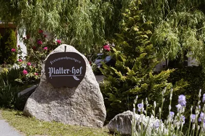 a sign on a rock in a garden at Platterhof in Tirolo